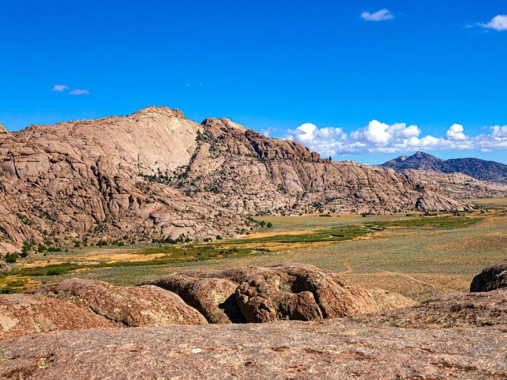 Split Rock, Wyoming, Oregon Trail marker with green grass of Sweetwater river flood plain