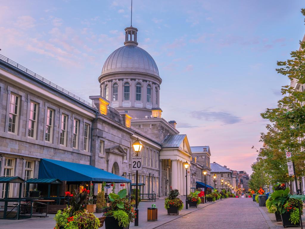 Montreal, Canada at the Old town with its famous cobbled streets at twilight, pretty flowers and street lights lining the street.