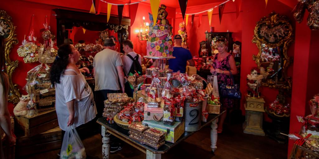 People admiring the cakes at Choccywoccydoodah, Brighton 