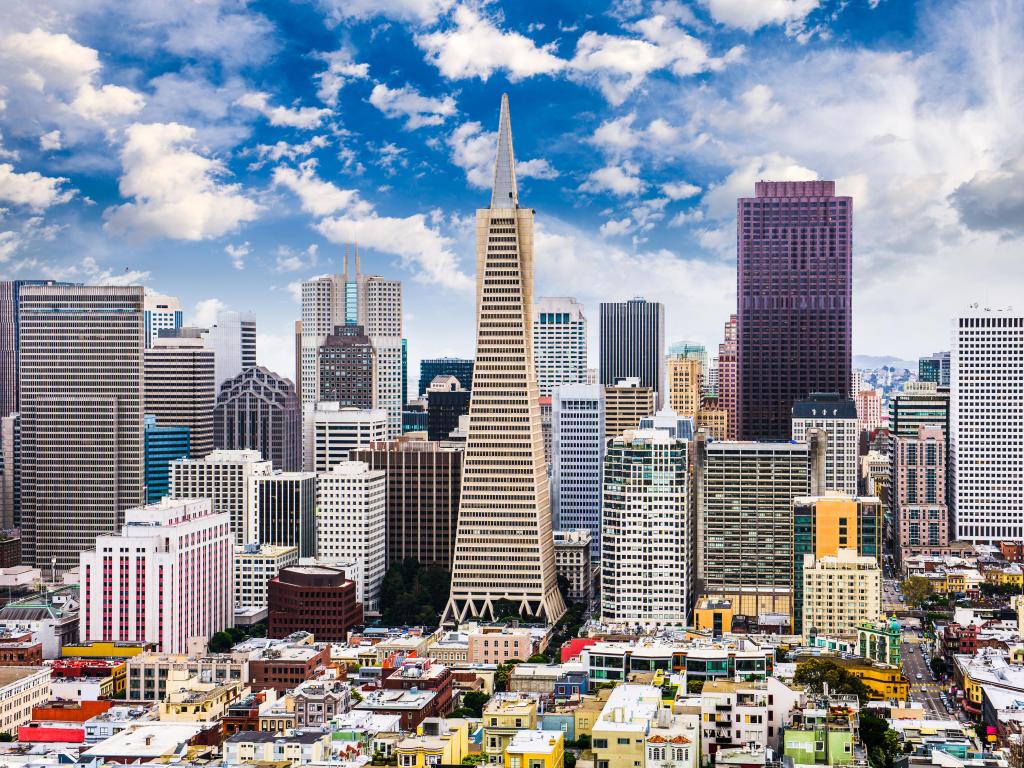 San Francisco, California, USA with the stunning skyscrapers in the foreground under a cloudy but blue sunny sky. 