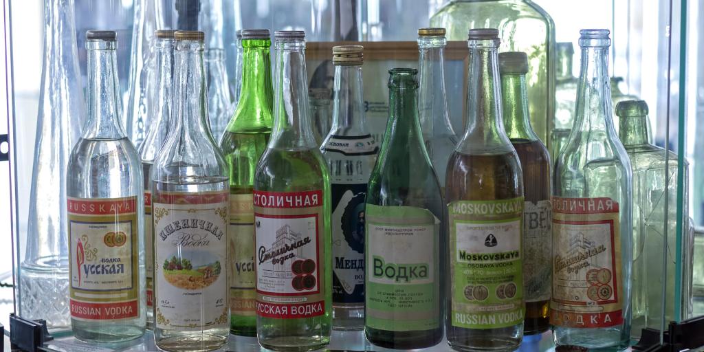 A collection of green and clear Russian vodka bottles on a shelf at the Vodka Museum, Uglich, Russia. 