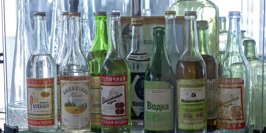 A collection of green and clear Russian vodka bottles on a shelf at the Vodka Museum, Uglich, Russia. 