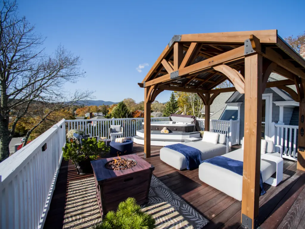 Penthouse Suite overlooking the ocean with a hot tub and two daybeds in view 