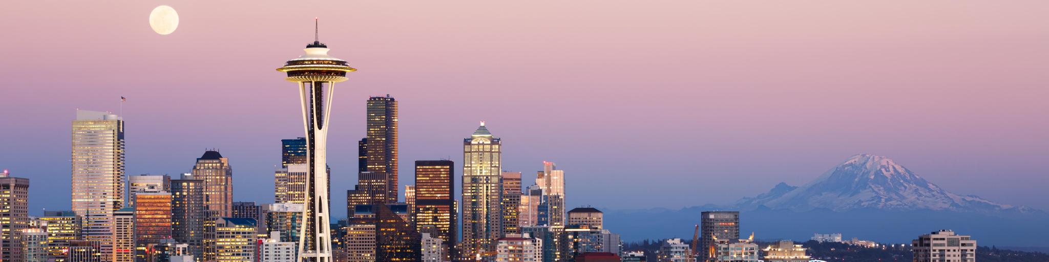 Seattle skyline at dusk with Mt Rainier in the background