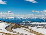 Panoramic view of snowy mountain ranges and highway along the Beartooth Scenic Highway. Montana and Wyoming, USA