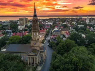 View of the city from an aerial POV, fiery sunset over the water
