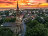 View of the city from an aerial POV, fiery sunset over the water