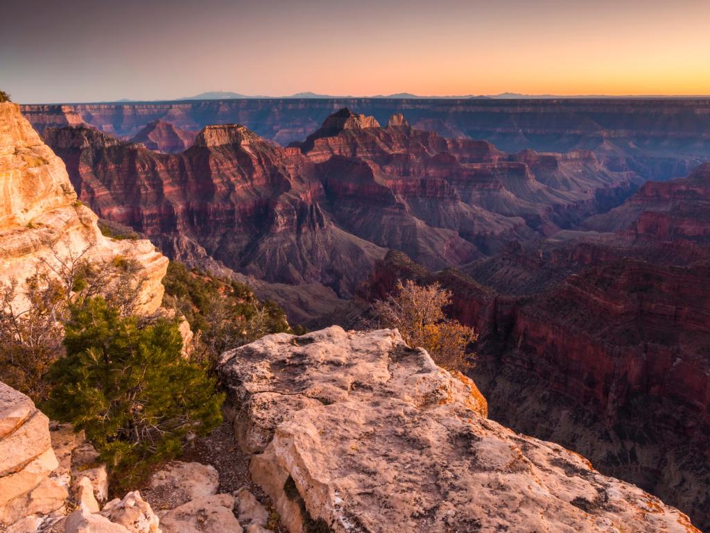 Grand Canyon National Park, Arizona, USA taken as a dramatic landscape photo at sunset with the canyons in the distance. 