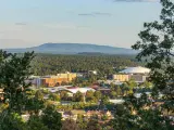 Aerial view over Flagstaff, Arizona, framed with forests and mountains in the distance