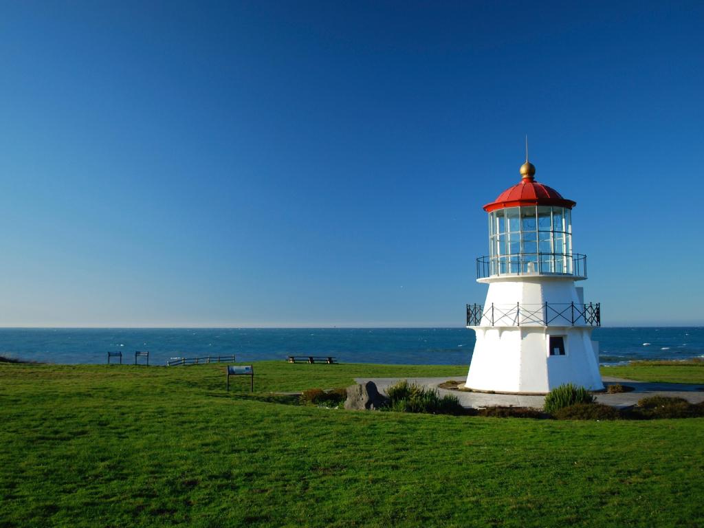 Shelter Cove lighthouse facing the ocean with blue sky, California