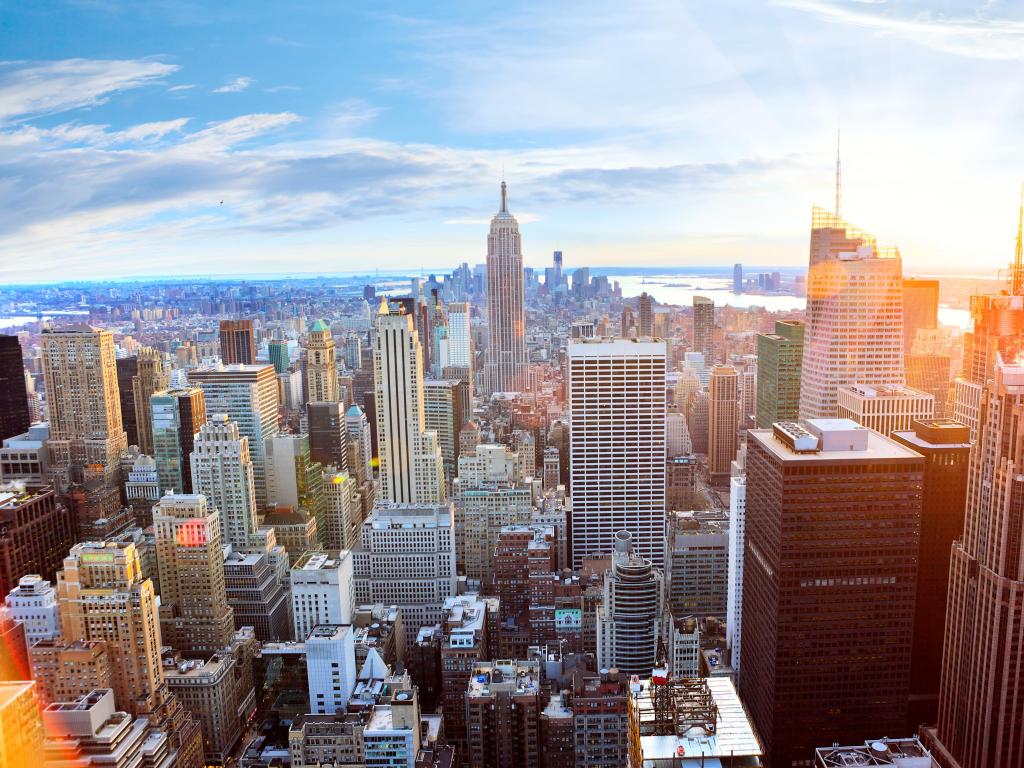 New York City, USA with an aerial view of Manhattan skyline at sunset.