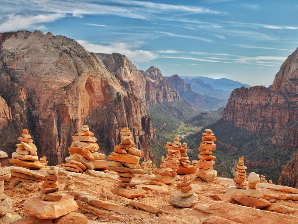 Stacks of rocks on a ledge above a deep wide valley 