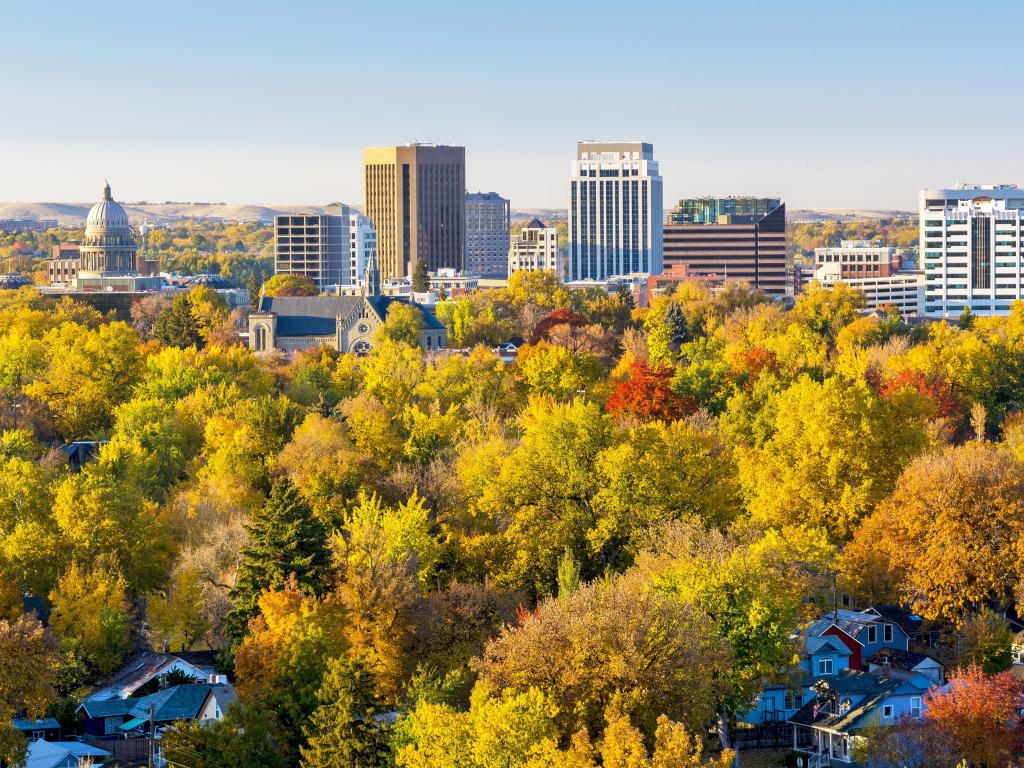 Boise, Idaho, USA taken with trees in the foreground in fall, the downtown city in the background and taken on a sunny day. 