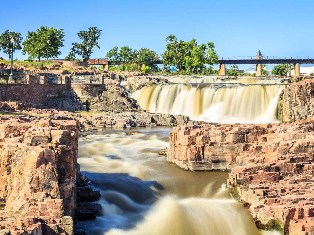 Beauty of nature in Sioux Falls, South Dakota, USA. The waterfalls that give the city its name are cascading down rugged rock formations on a sunny day.