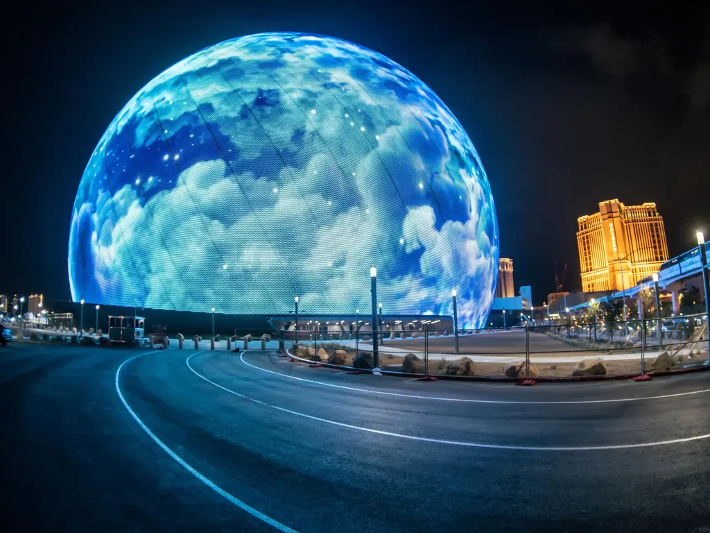 MSG Sphere is lit up with projected clouds during night time