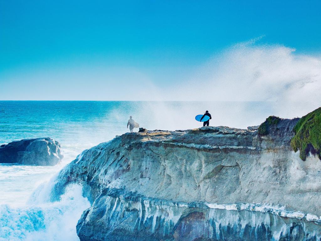 Surfers prepare to jump into the ocean at Steamer Lane, Santa Cruz California