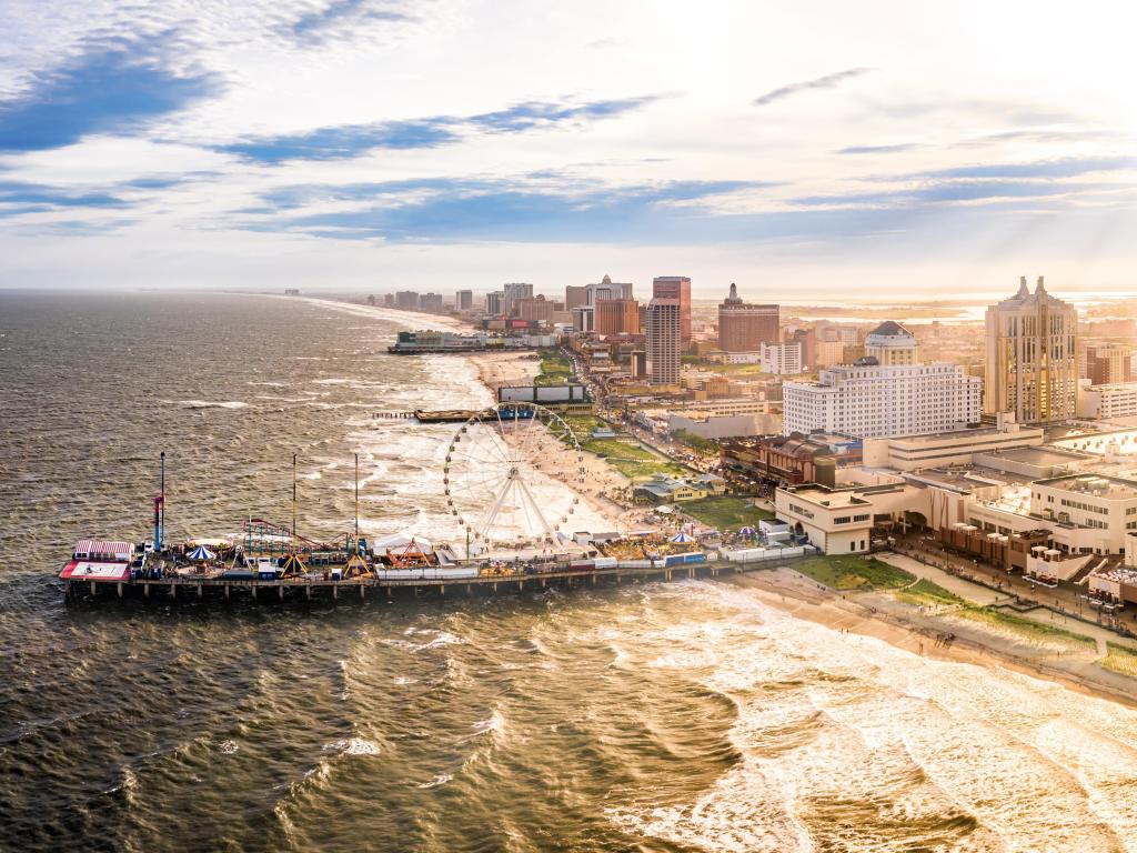 Atlantic City, USA taken at late afternoon as an aerial panorama of along the boardwalk with skyscrapers along the beach and a ferris wheel on the broad walk. 