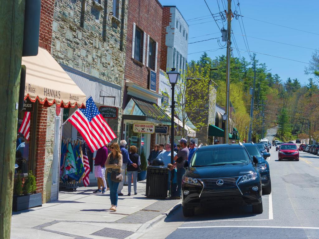 Quaint store fronts adorned with flags in downtown Blowing Rock, North Carolina on a sunny day