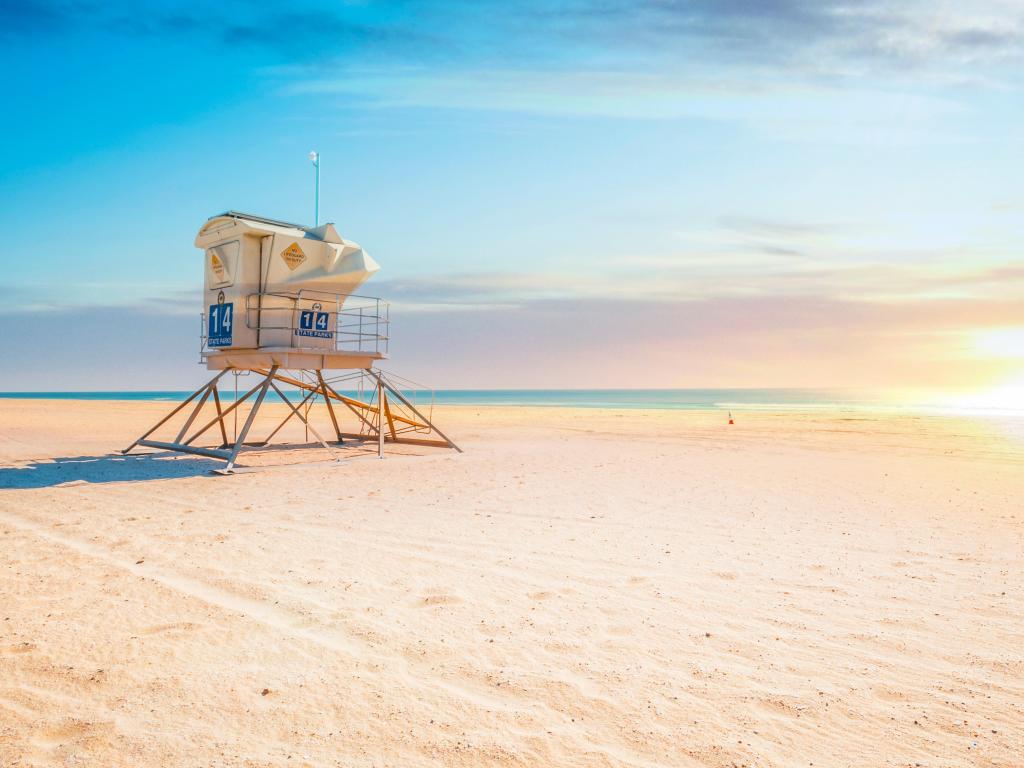 Sunrise at Huntington Beach, California with white sands and a clear blue sky