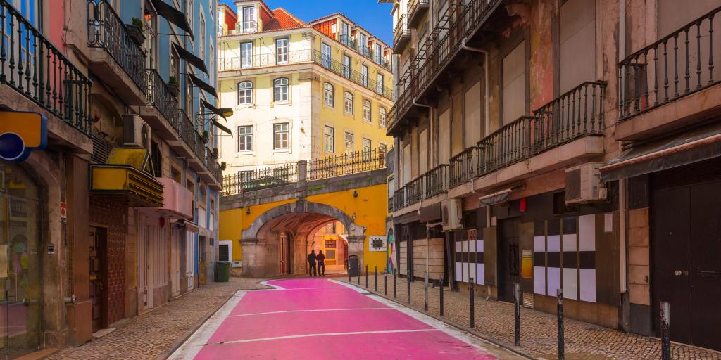 People walk down the famous Pink Street in Lisbon's Cais do Sodre area