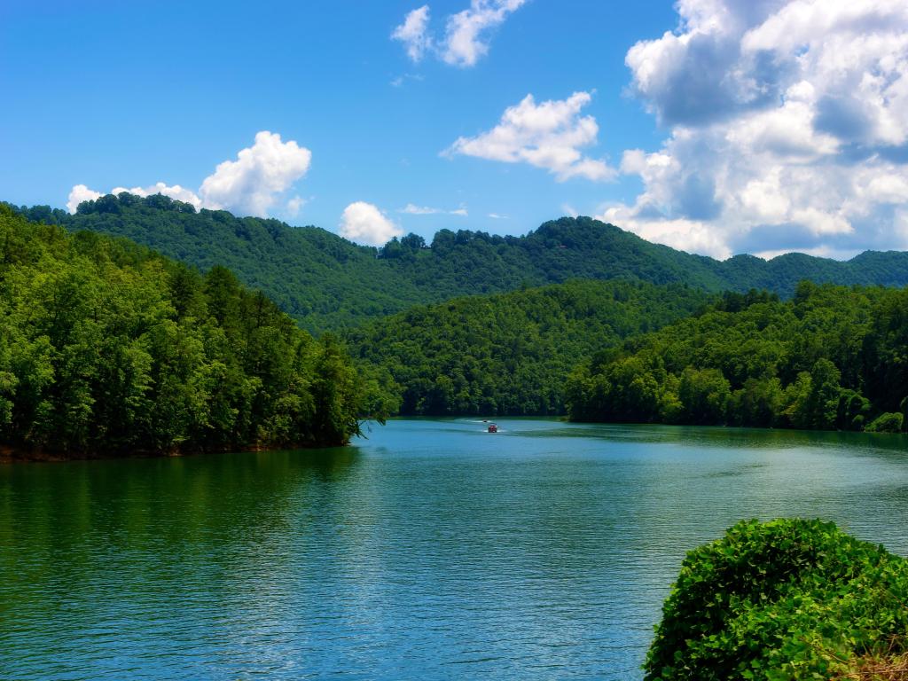 River view with two boats seen from a moving train traveling through the Nantahala National Forest