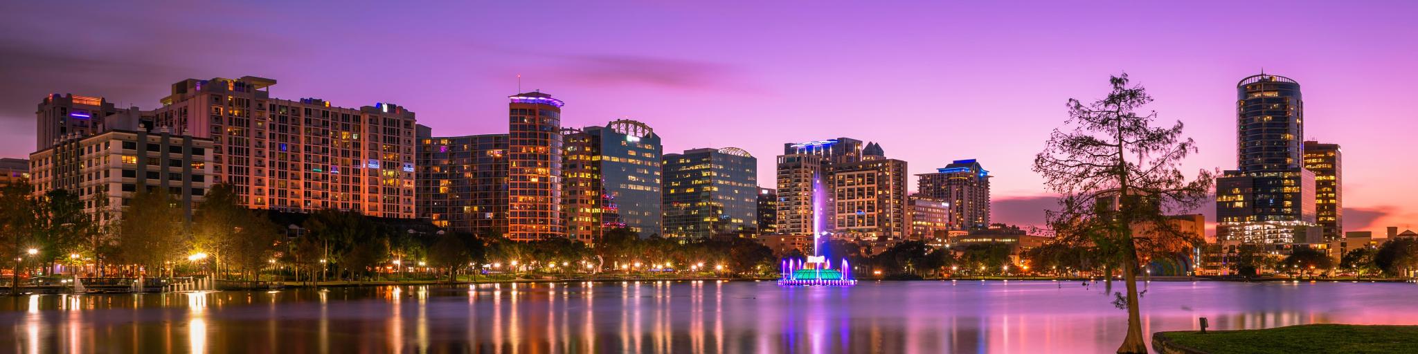 Colorful sunset above Lake Eola and city skyline in Orlando, Florida, USA