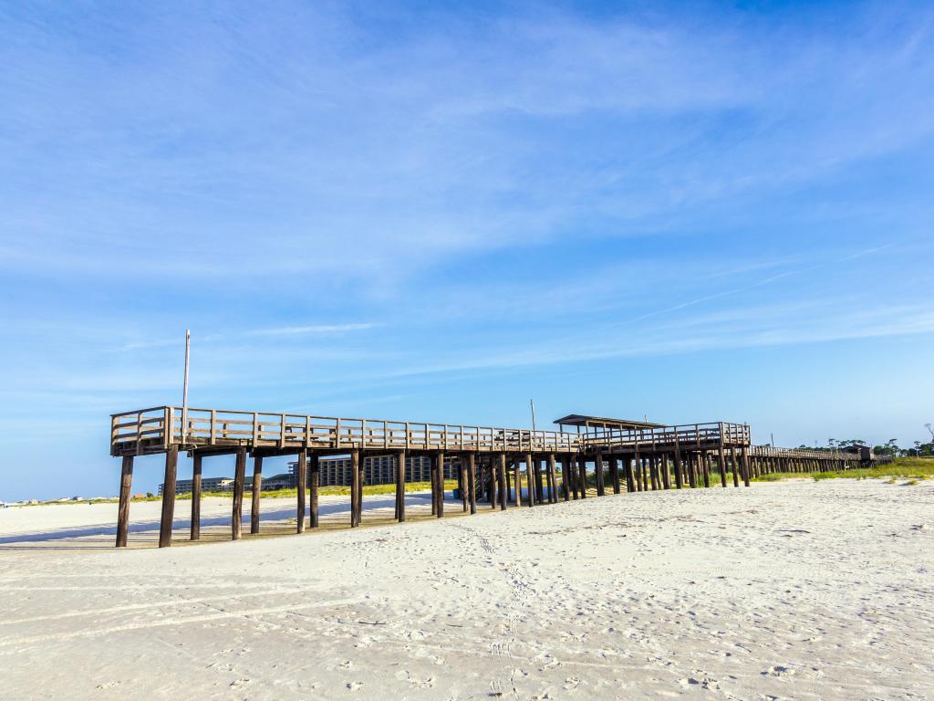 Wooden pier and sandy beach at Dauphin Island