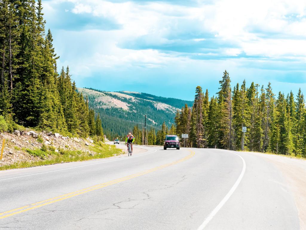 Cyclist going round a bend on the Hoosier Pass, Colorado on a sunny day