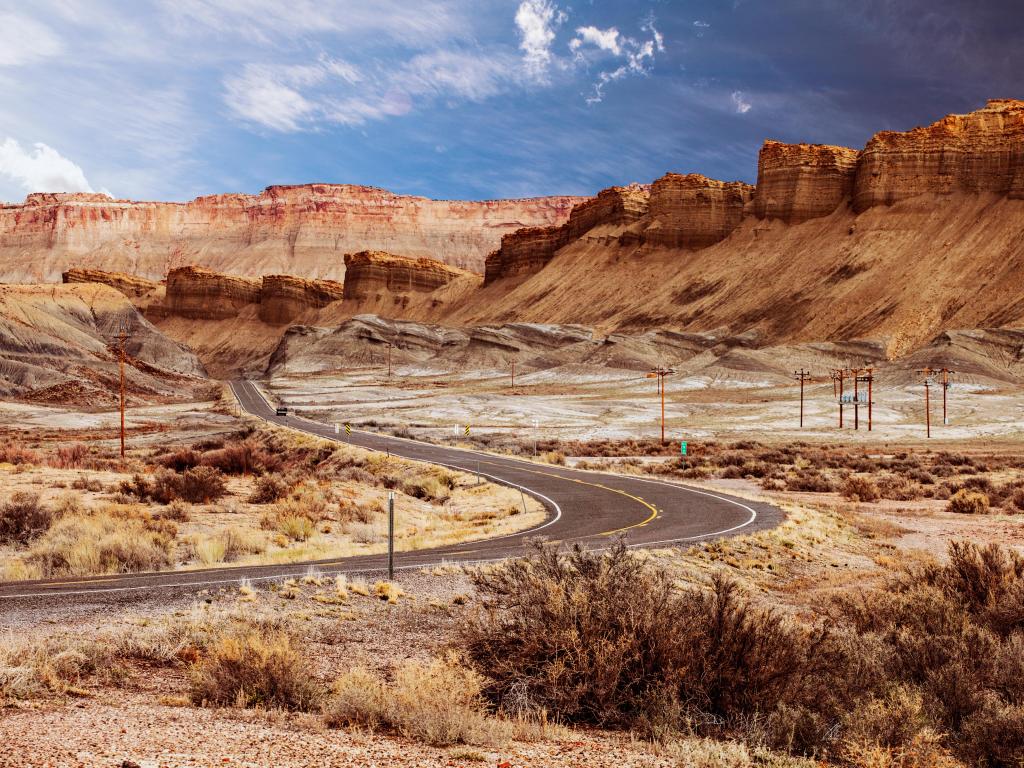 Road twisting among red rock scenery on a cloudy day