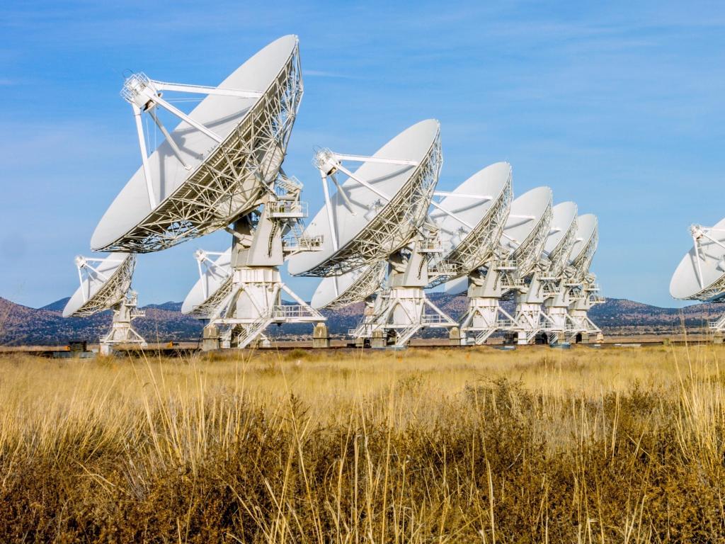 Close-up of the impressive satellite antenna array at the Very Large Array New Mexico, lined up along desert landscape