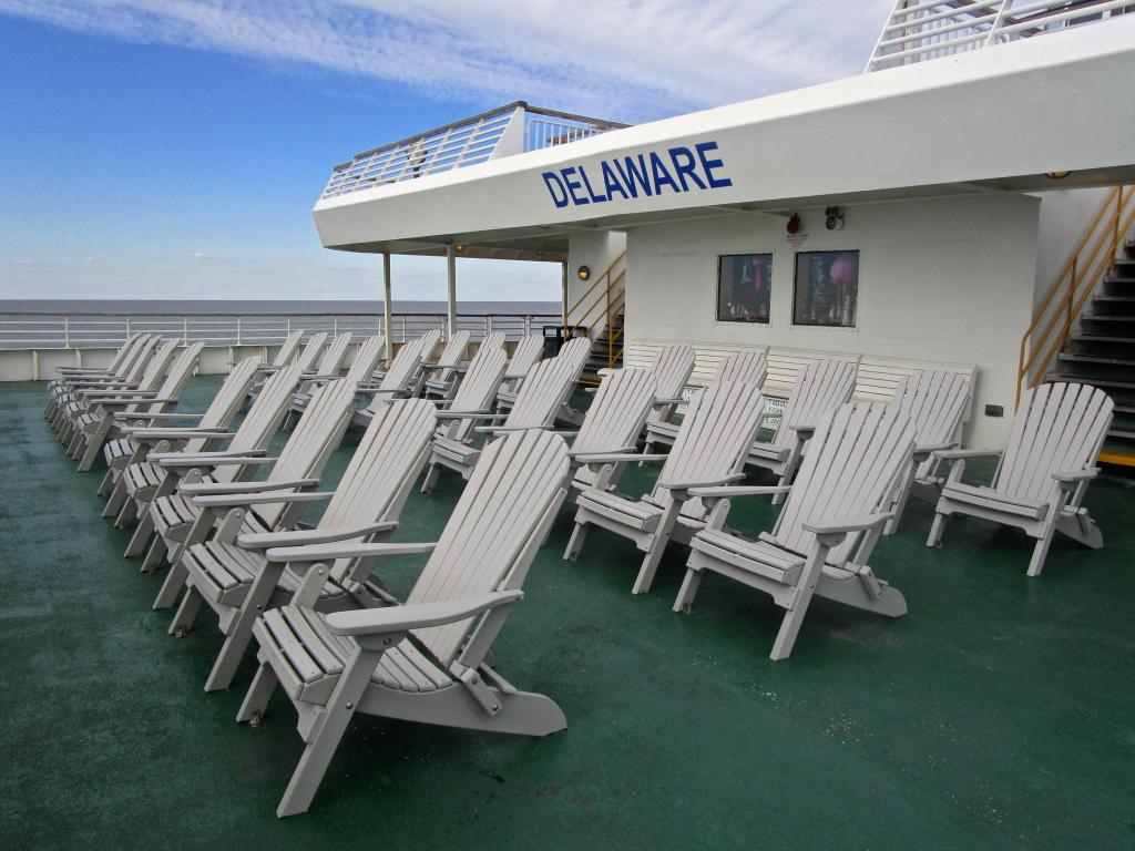 White deck chairs with a view of Delaware Bay from the Cape May to Lewes ferry