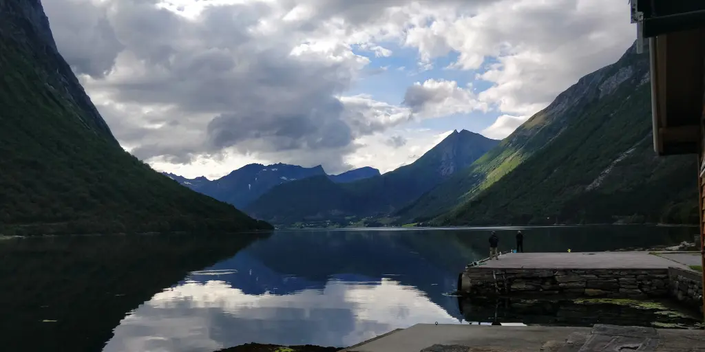 Mountains reflect on the water in Oye, Norway