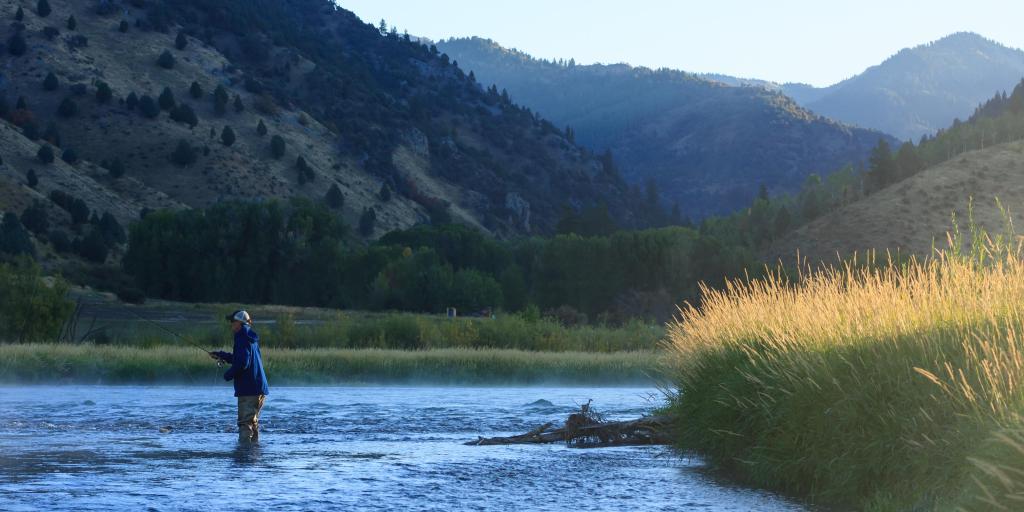A man goes fly fishing on Snake River in Swan Valley, Idaho