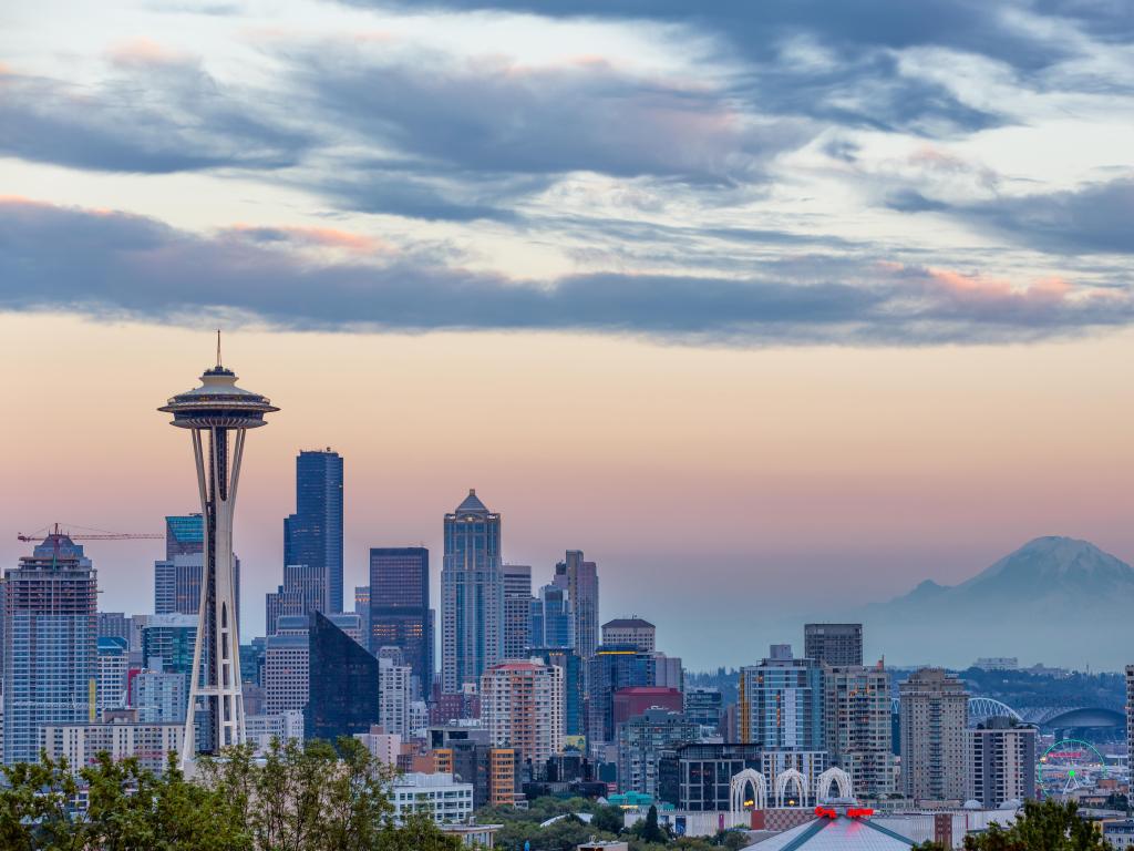 Highrise downtown buildings with mountain in the distance in hazy pink light