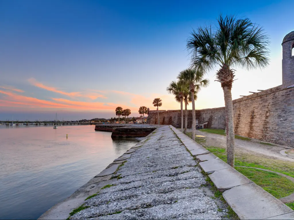St Augustine, Florida, USA taken at the Spanish fort at sunset with palm trees lining the edge.