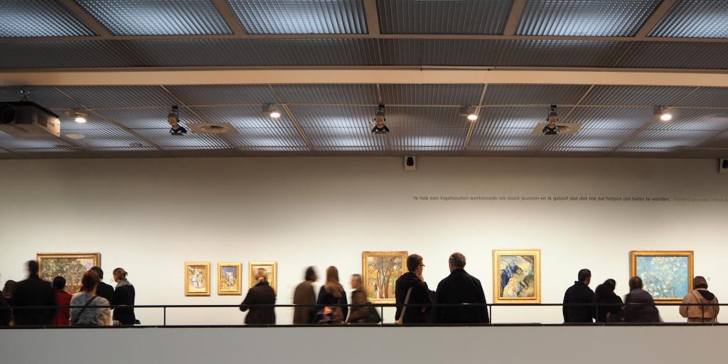 People looking at the artwork in the Van Gogh Museum, Amsterdam 