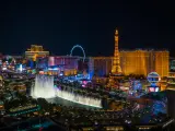 Night view of Las Vegas with neon-lit buildings and the Bellagio Fountain in focus