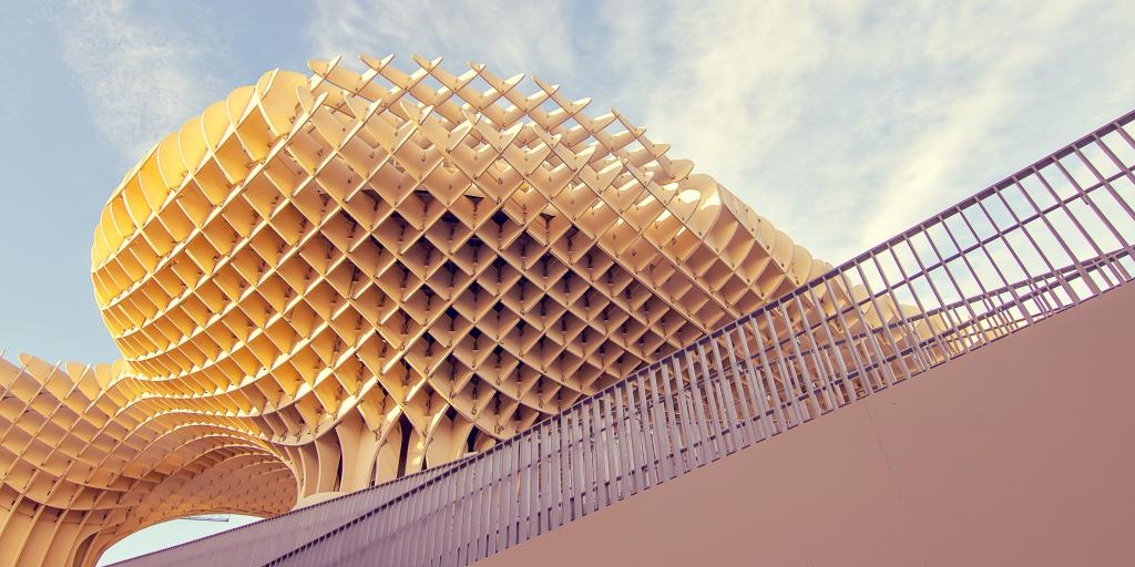 The wooden grid pattern of Metropol Parasol against a blue sky in Seville