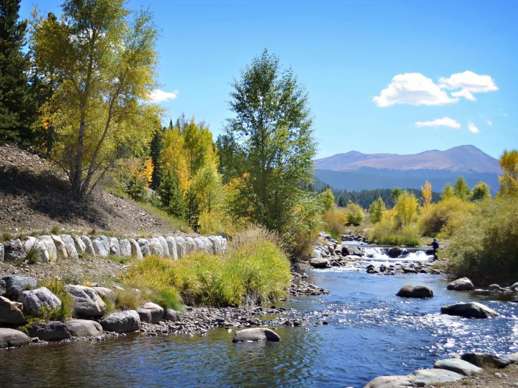 Breckenridge river view, Colorado in springtime with green vegetation around and a sunny sky