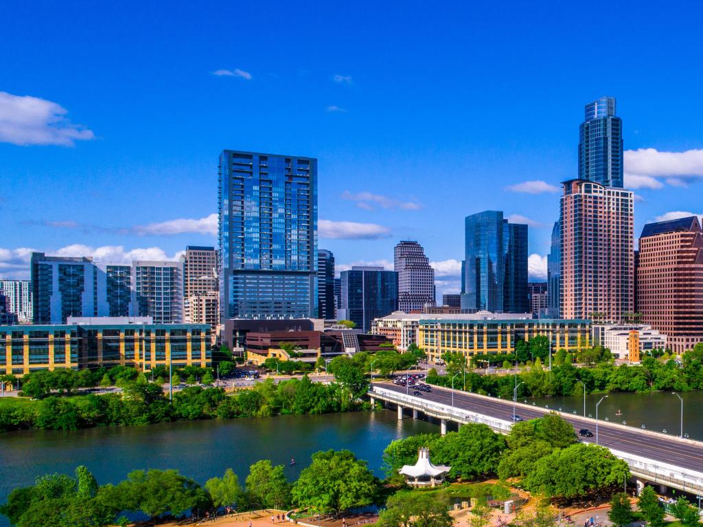 Austin, Texas, USA with the city skyline during mid-day sunny summer perfect blue sky with entire city scape office buildings capital cities cityscape auditorium shores Panoramic