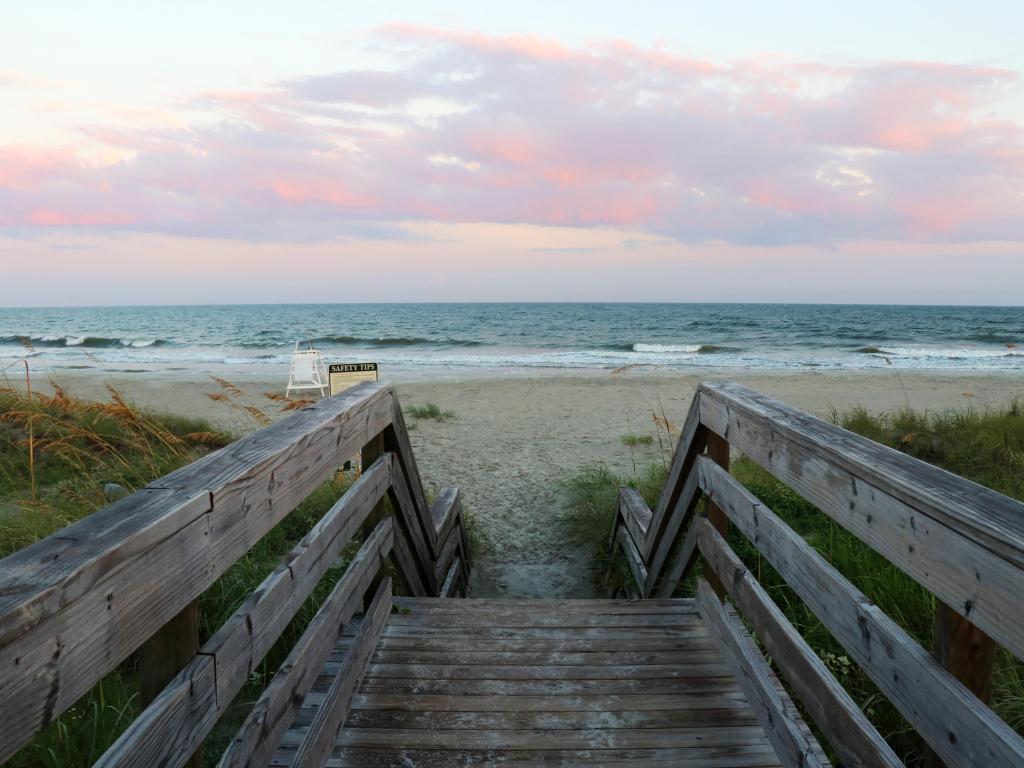 Huntington Beach State Park, Myrtle Beach area, South Carolina, USA with a wooden boardwalk and stairs to the ocean beach over sand dunes.