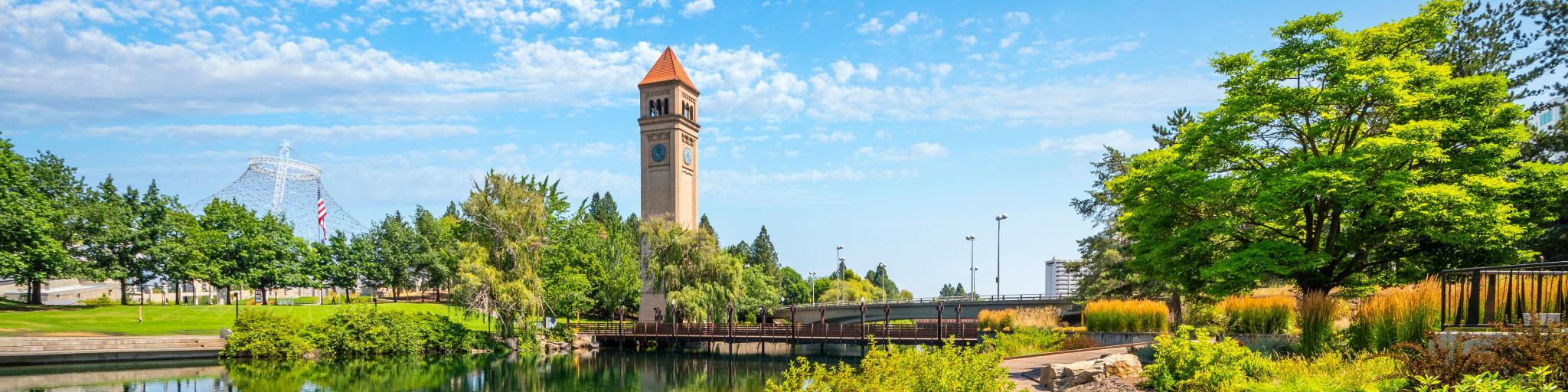 A summer day view of the Great Northern Clock Tower, Expo Pavilion, Spokane River