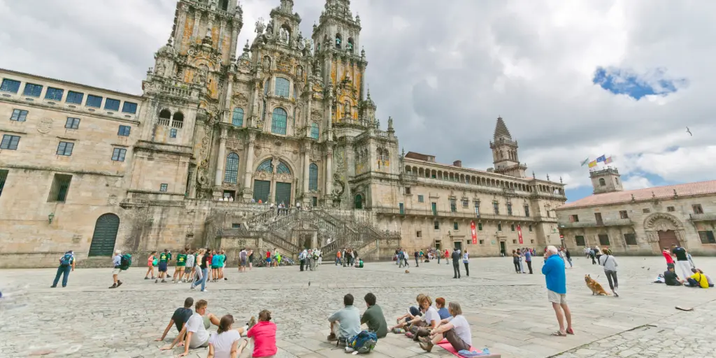 Pilgrims on the Camino de Santiago arriving to Santiago de Compostela's famous cathedral