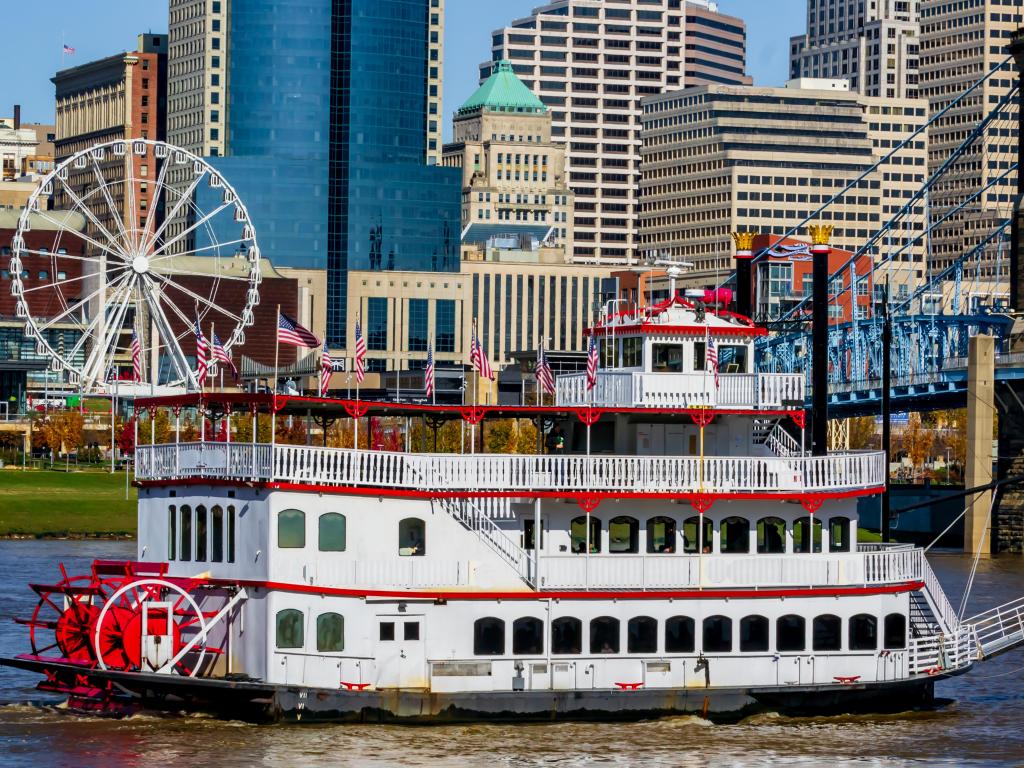 Colorful Cincinnati river front looking from Kentucky with steam boat and ferris wheel. 