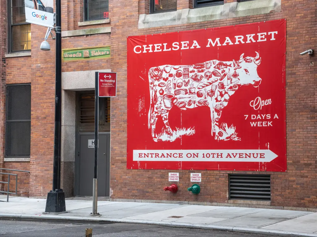 Close up of Chelsea Market red and white cow sign on the wall on a building in Meatpacking District in New York City.