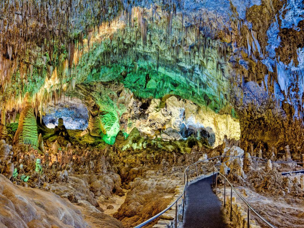 Underground pathway through the Big Room, with green and blue lights marking the way along Carlsbad Caverns, New Mexico