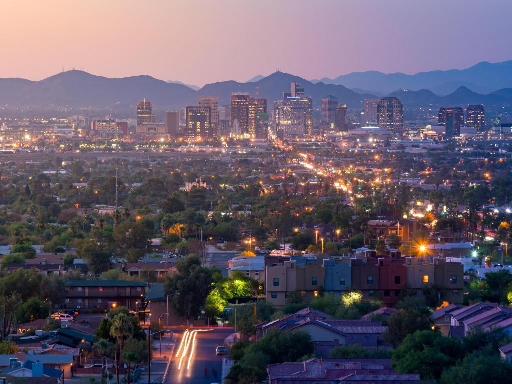 Phoenix, Arizona, USA with a view of the downtown city at sunset with mountains in the distance. 