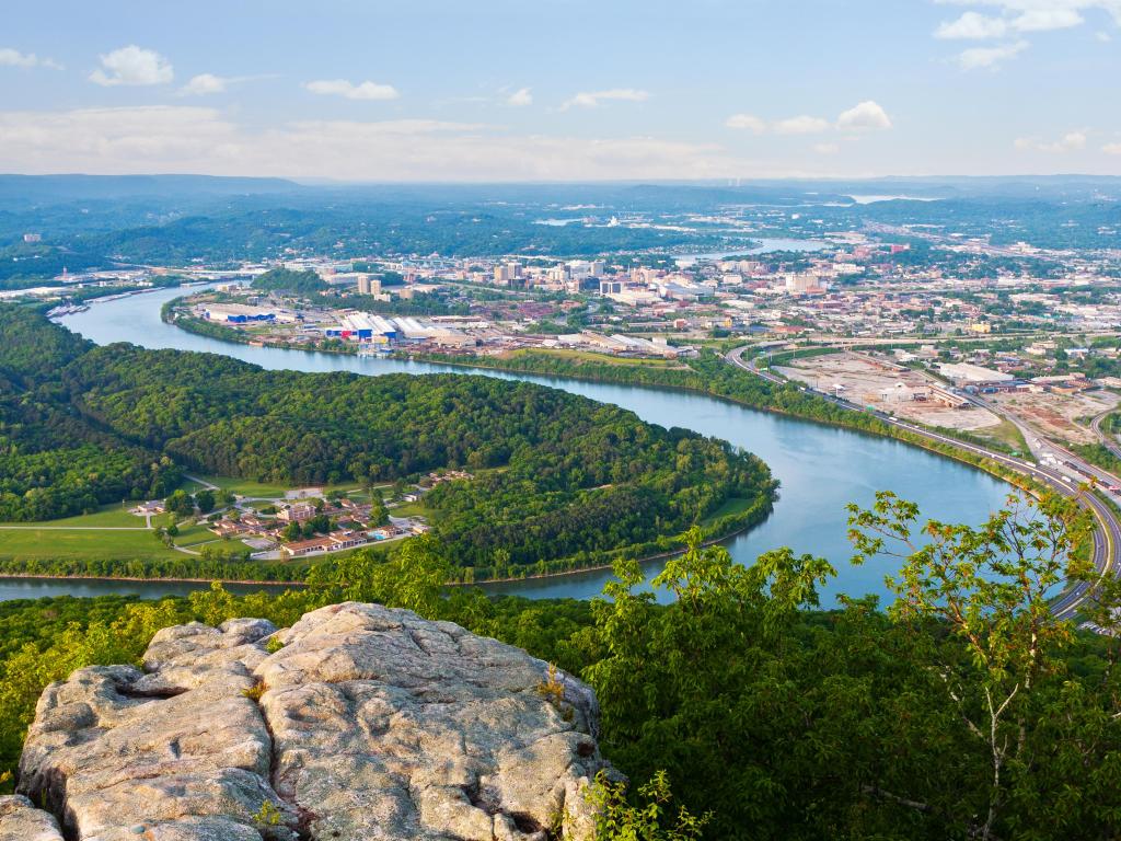 Chattanooga, Tennessee, USA taken at the downtown riverfront as an aerial view on a  sunny day with rocks in the foreground. 