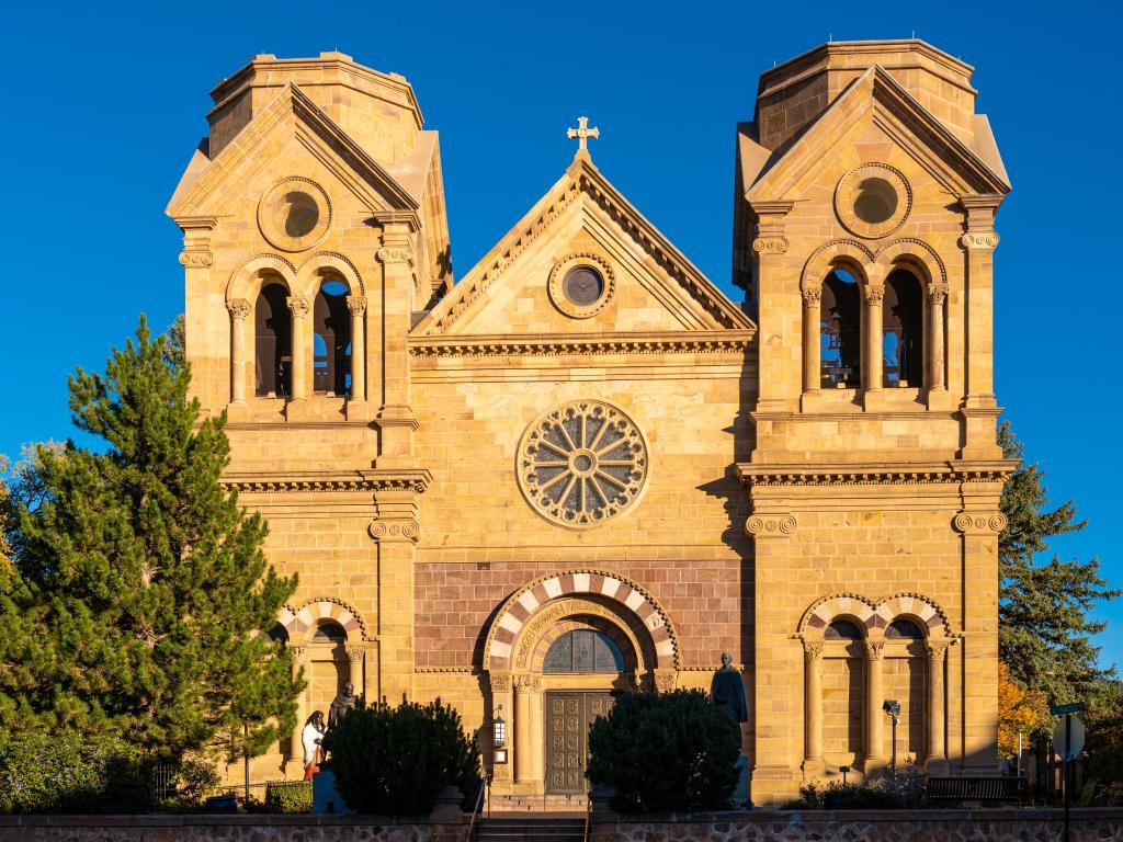 The facade of Cathedral Basilica of St. Francis of Assisi illuminated by the sun rays in Santa Fe, the capital of New Mexico