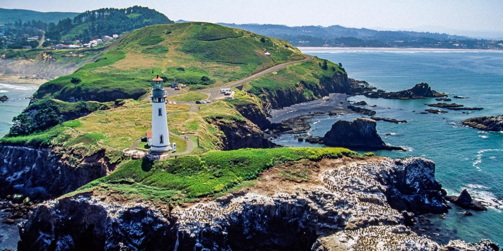 Aerial image of Yaquina Head Lighthouse on the rugged coastline in Oregon, USA